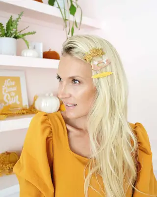 women with three large statement barrettes in curly hair
