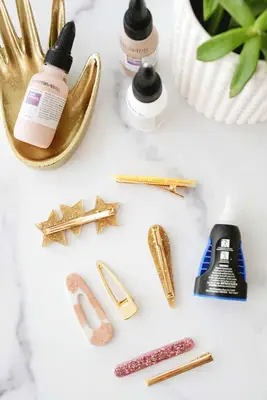 various barrette tops and barrette backings being glued together
