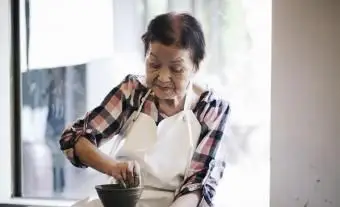 קשישה שעובדת עם קרמיקה
