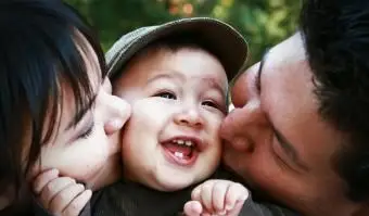 Mère espiègle tenant son fils à l'extérieur