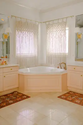 a tub between 2 pink vanities