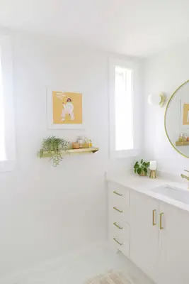 gold shelf with print above it