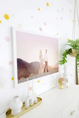 family photo of husband and wife hanging above dresser