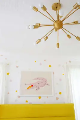 brass light fixture in front of pink alligator print