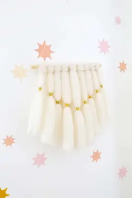yarn wall hanging on star wallpaper wall