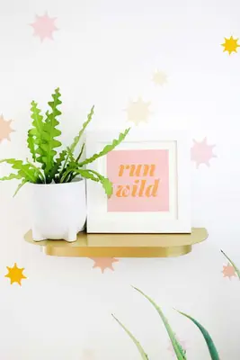brass shelf with plant and pink 