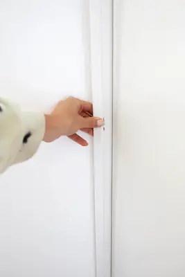 holding trim piece against wardrobe