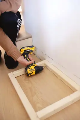 screwing wardrobe base into wall