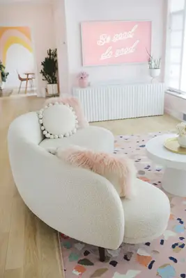 side view of white curved boucle couch