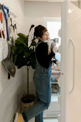 Elsie smiling and opening the fridge and pulling out a box of pie crush