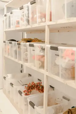 wooden shelves with clear tote bins on it