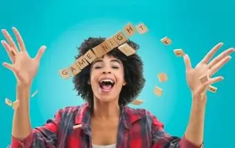 Frau, die Scrabble-Buchstabenspielsteine ​​wirft