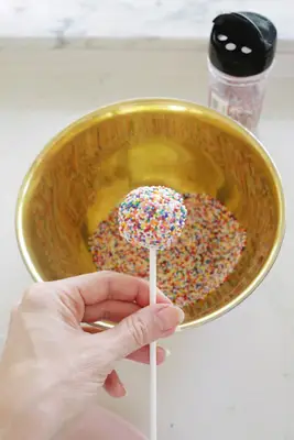 adding sprinkles to cake pops