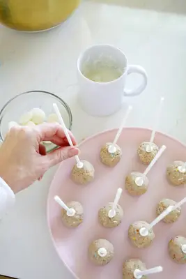 adding sticks to cake pop balls