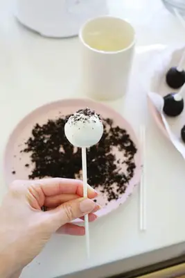 adding crushed oreos to oreo cake pop balls