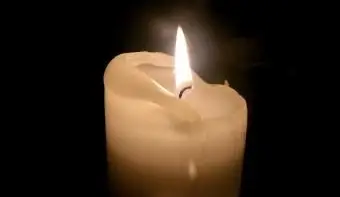 Osvetlená sviečka v tmavej komore