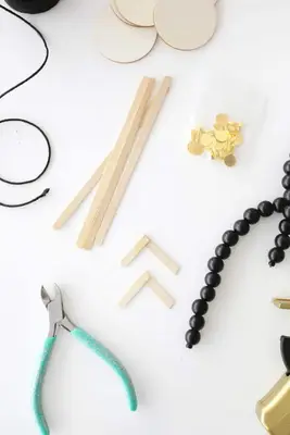 wooden popsicle stick quarters glued together to make legs