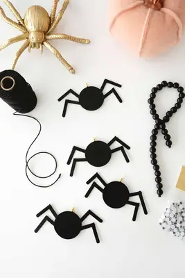 wooden spiders painted black