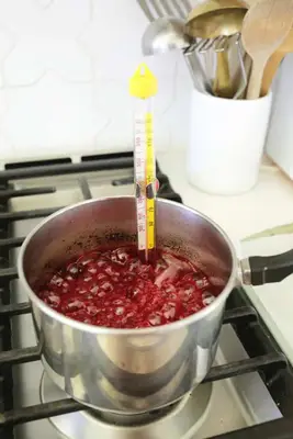 boiling candy coating on stove for easy candy apples