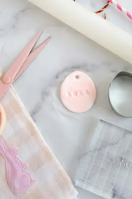 name stamped onto air dry clay egg