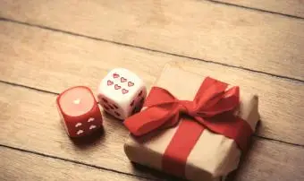 美しい贈り物と素晴らしい茶色の木製の背景に小さなサイコロ