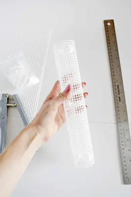 someone rolling up mash cover with a ruler and snap setter by it