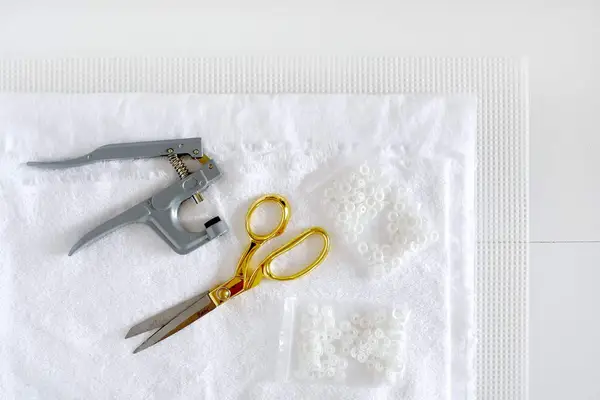 cotton terrycloth fabric, cotton fannel, gold scissors, mash canvas, snaps, and snap setter