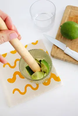 muddling a Caipirinha drink 