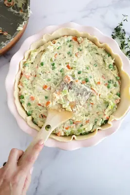 adding filling for chicken pot pie