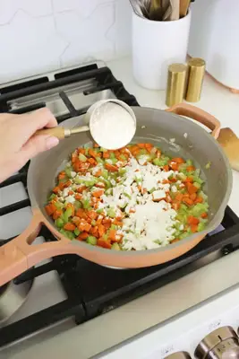 adding flour to chicken pot pie