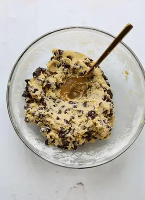 cookie dough mix in a mixing bowl with a spoon