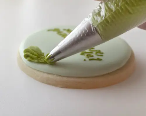 adding icing to cookies