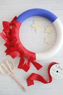 tied red ribbons around wreath