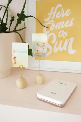 Family photo display in home on pink shelf