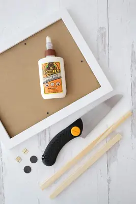 frame, wooden dowel, compact hand saw, hinges and magnets with wood glue