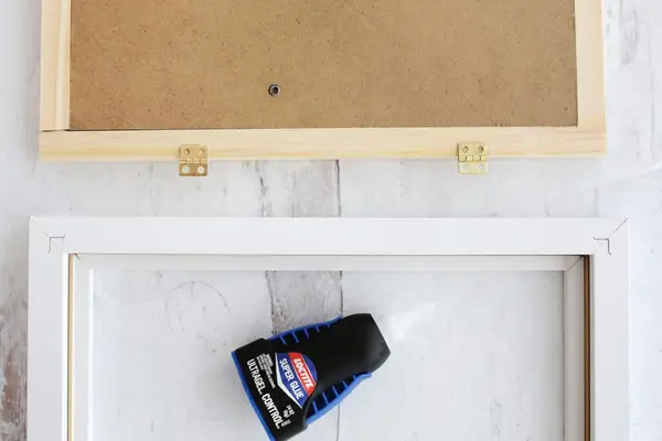 hinges being glued onto picture frame
