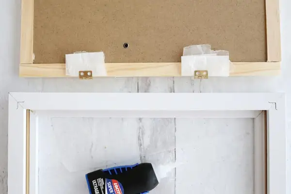 hinges being glued onto picture frame