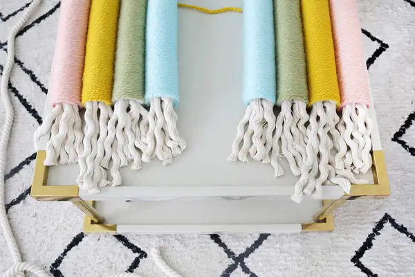 the ends of the 4 yarn wrapped pool noodles with heavy rope hanging out
