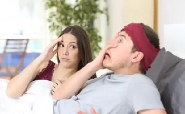 Uomo imbarazzato a letto con la fidanzata