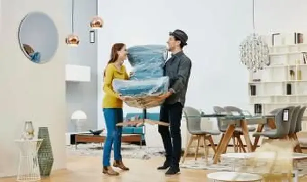 Glückliches Paar mit neuem Sessel