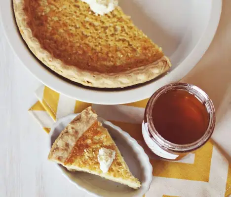 half of a pie, a piece of pie and a jar of honey.