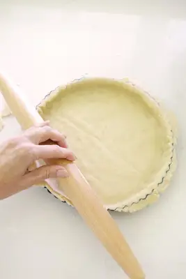 Adding dough to a tart pan for apple tart