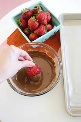 Dipping strawberries for chocolate covered strawberries