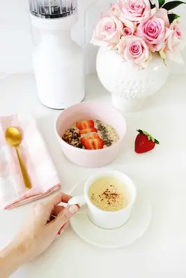 smoothie bowl with strawberries and coffee in front of beast blender
