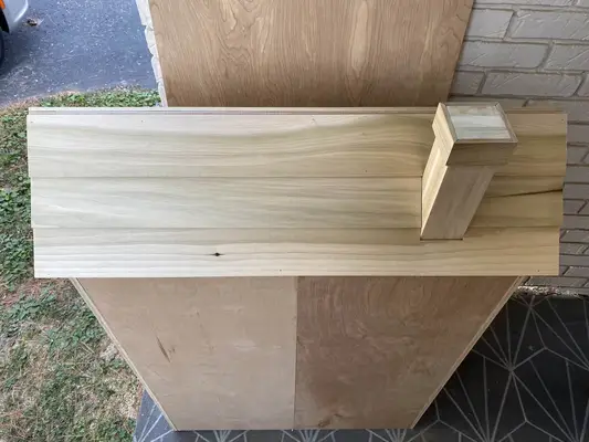 chimney on the unpainted roof of the dollhouse