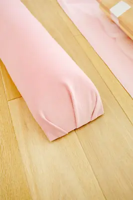 fabric wrapped around end of bolster