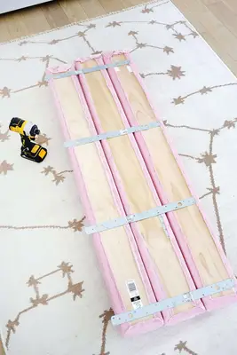 three half round bolsters with metal straps attached