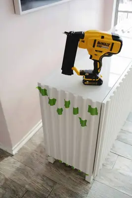 nail gun sitting on fluted sideboard