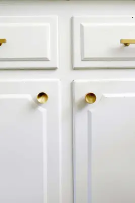 white kitchen cabinets with gold knobs