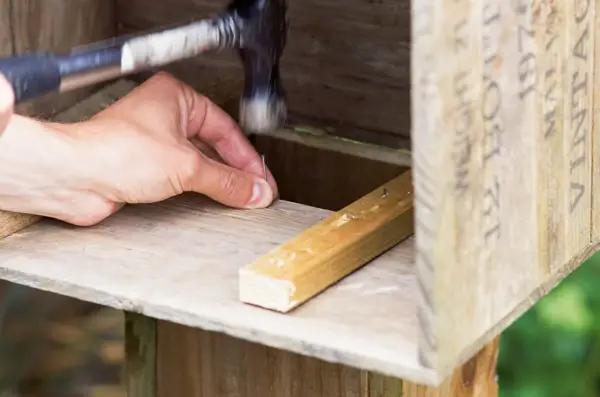 How to make a hedgehog house - attaching the tunnel to the crate